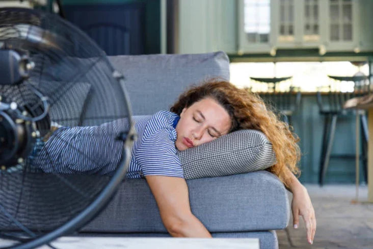 Woman Sleeping in the summer with fan
