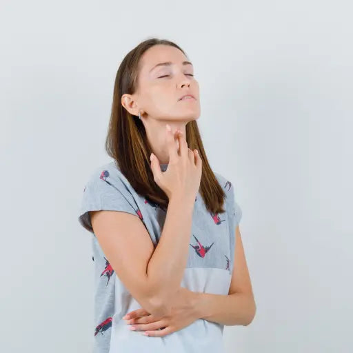 Woman touching her throat because of dry throat. Mouth Breathing causes drying of the throat